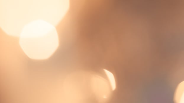 Warm glowing bokeh lights in a golden festive background for holiday celebrations photo