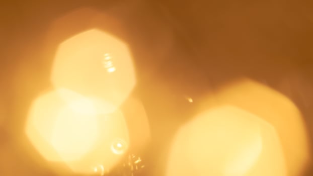 Golden bokeh festive lights with a soft, warm glow creating a cheerful atmosphere photo