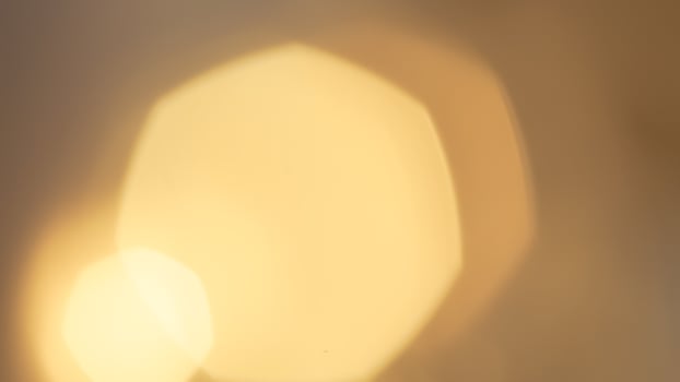 Warm glowing bokeh lights in a golden festive background for holiday celebrations photo
