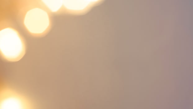 Golden bokeh festive lights with a soft, warm glow creating a cheerful atmosphere photo