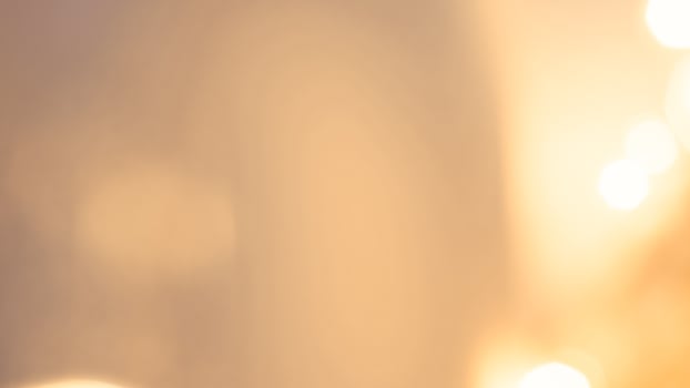 Warm glowing bokeh lights in a golden festive background for holiday celebrations photo