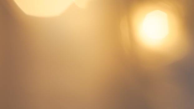 Warm glowing bokeh lights in a golden festive background for holiday celebrations photo