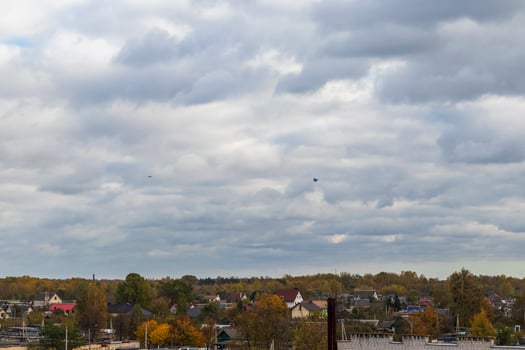 Silhouettes of the MIG fighter jets in the cloudy sky. Military photo