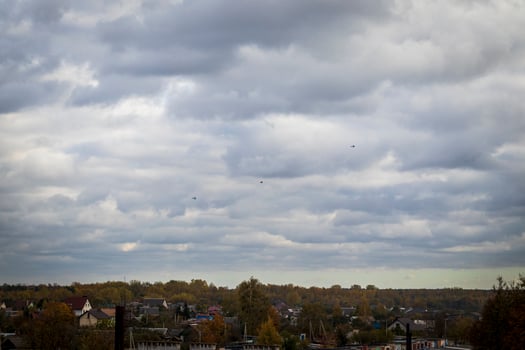 Silhouettes of the MIG fighter jets in the cloudy sky. Military photo