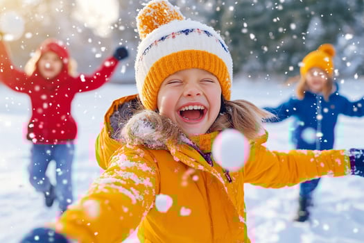 Kids laughing and playing in snow during a joyful snowball fight on a sunny winter day photo
