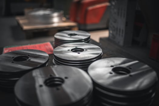 Close up of small metal disks stacked up after production photo