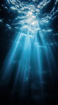 Beautiful underwater landscape showcasing sun rays penetrating clear ocean water at midday photo