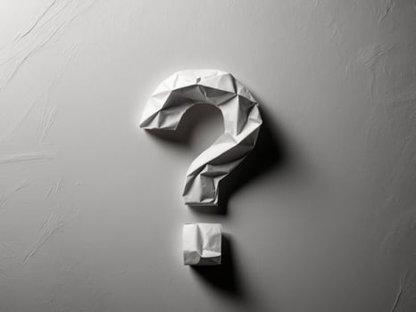 Question mark origami paper on grey background photo