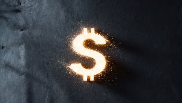 A dollar sign glowing on a black background photo