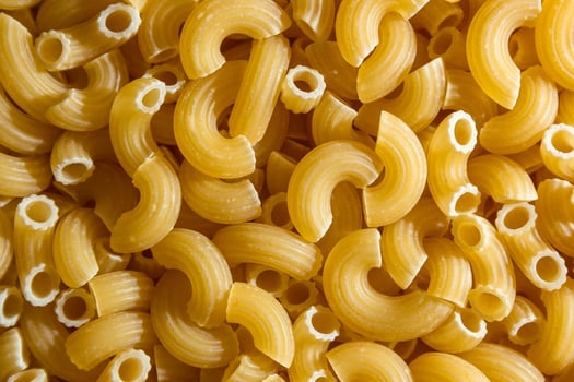 Uncooked Chifferi Rigati Pasta. A Culinary Canvas of Chifferi Rigati, Creating a Lively and Textured Background for Gourmet Cooking. Dry Pasta. Raw Macaroni - Top View, Flat Lay photo