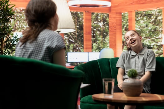 Adolescent in a confidential therapy session addressing anxiety and low self esteem issues. Therapist helps her manage emotional distress, encouraging resilience and confidence boost. photo