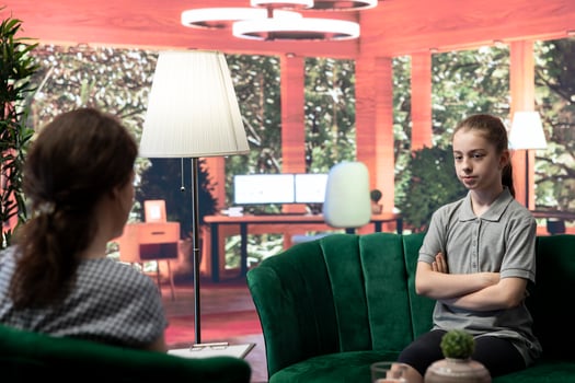 Girl opening up about problems in counseling session focused on self esteem issues. Teenager seeks guidance and professional advice to help with trauma and hormonal shifts. Psychotherapy. photo