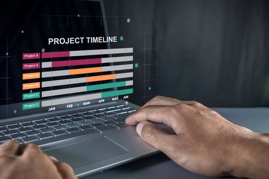 Man working on laptop to check the project timeline, milestones and planning progress on virtual screen photo