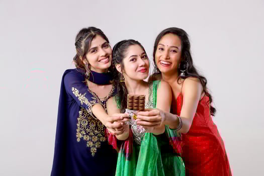 Gorgeous Three Besties Friends Showing Chocolate Bar at Camera photo