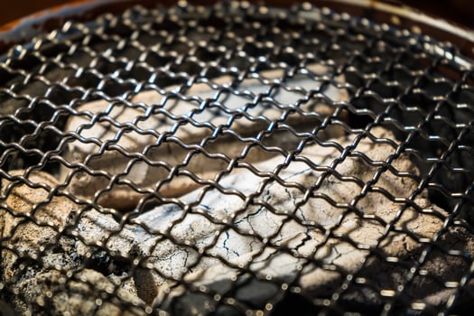 Grill Preparation with Glowing Charcoal for BBQ Party photo