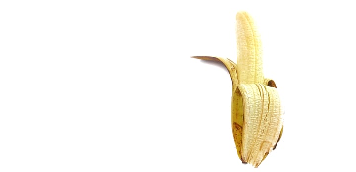 Banana isolated. Ripe peeled banana on a white background with copy space photo