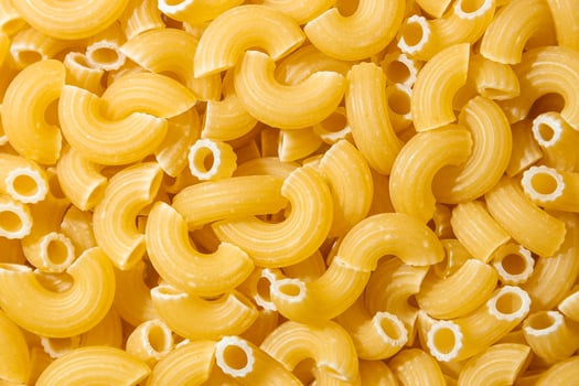 Uncooked Chifferi Rigati Pasta. A Culinary Canvas of Chifferi Rigati, Creating a Lively and Textured Background for Gourmet Cooking. Dry Pasta. Raw Macaroni - Top View, Flat Lay photo
