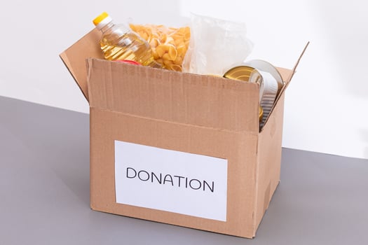Donation Box of Free Food. Carton Box with Canned Food, Cereals and Grocery. Meal Reserves. Emergency Food Storage in Case of Crisis. Free Social Help, Blessings and Care. Strategic Food Supplies photo