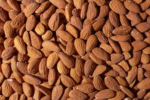 Scattered Almonds. Background from Almond Nuts. Natural High-Calorie Snacks photo