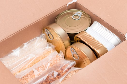 Food Reserves or Donation Box. Carton Box with Canned Food, Cereals and Grocery. Emergency Food Storage in Case of Crisis. Free Social Help, Blessings and Care. Strategic Food Supplies photo