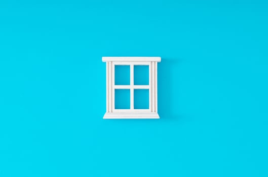 White window frame on light blue background. Minimal concept and simplicity. Flat lay. photo