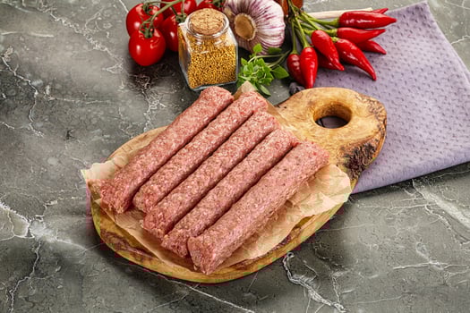 Raw beef kebab sausage for grill photo
