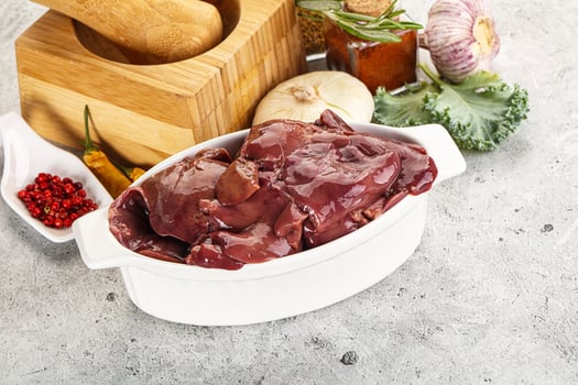 Raw uncooked chicken liver in the bowl photo