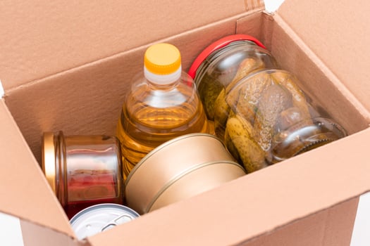 Food Reserves or Donation Box. Carton Box with Canned Food, Cereals and Grocery. Emergency Food Storage in Case of Crisis. Free Social Help, Blessings and Care. Strategic Food Supplies photo