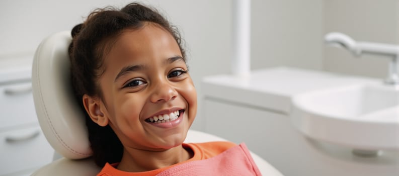 A cheerful AfricanAmerican child receives dental care with a bright gleaming smile photo