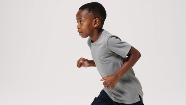 Image of an isolated African American boy running against a white background photo