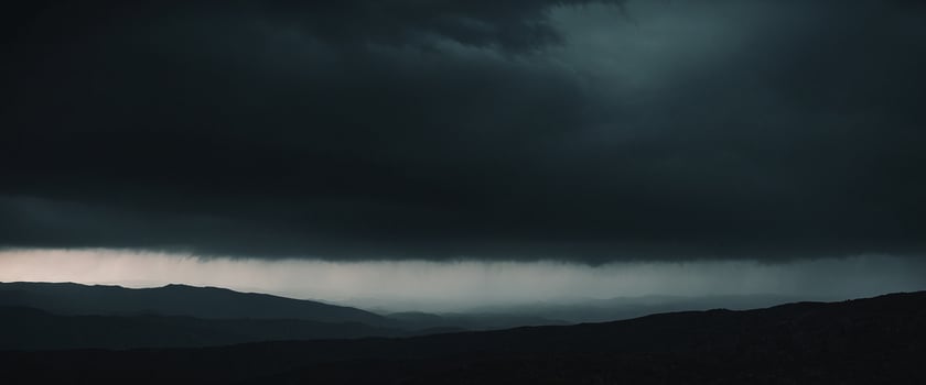 Dark storm clouds over mountains photo