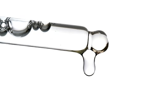 Dropper pipette with delicious serum with bubbles close-up. photo