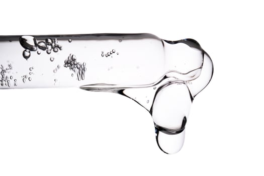 Dropper pipette with delicious serum with bubbles close-up. photo