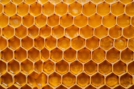 Seamless honeycomb pattern with warm golden hues blending from dark amber to bright yellow texture photo
