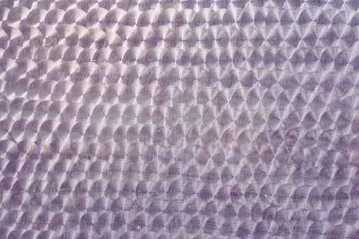 A holographic surface of light lilac color with space for copying. Iridescent film texture photo