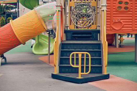 An image of a colorful playground without children. Modern slides and mazes are made of plastic. With space to copy photo