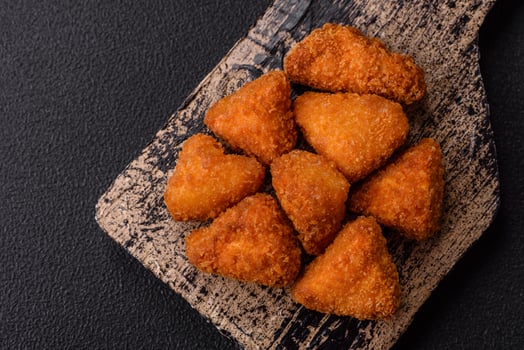 Brie cheese or camembert fries in breading, fast food, takeaway photo