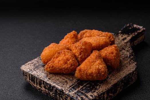Brie cheese or camembert fries in breading, fast food, takeaway photo