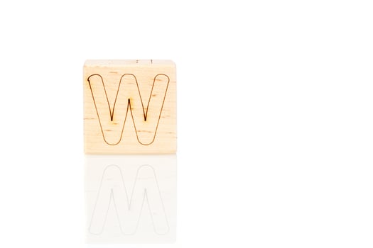 Wooden cubes with letters W on a white background photo