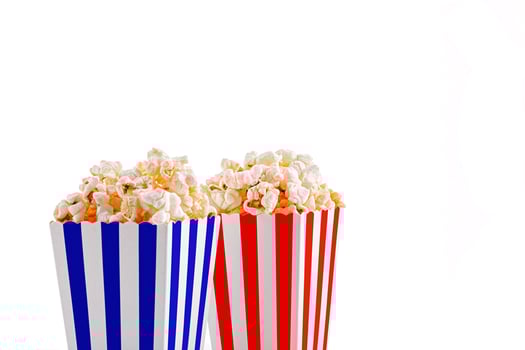 Glass with popcorn on a white background photo