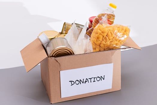 Donation Box of Free Food. Carton Box with Canned Food, Cereals and Grocery. Meal Reserves. Emergency Food Storage in Case of Crisis. Free Social Help, Blessings and Care. Strategic Food Supplies photo