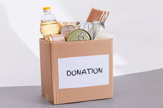 Donation Box of Free Food. Carton Box with Canned Food, Cereals and Grocery. Meal Reserves. Emergency Food Storage in Case of Crisis. Free Social Help, Blessings and Care. Strategic Food Supplies photo