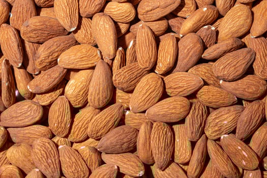 Scattered Almonds. Background from Almond Nuts. Natural High-Calorie Snacks photo