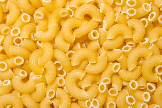 Uncooked Chifferi Rigati Pasta. A Culinary Canvas of Chifferi Rigati, Creating a Lively and Textured Background for Gourmet Cooking. Dry Pasta. Raw Macaroni - Top View, Flat Lay photo