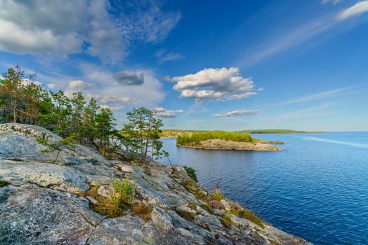 Beautiful stones and pine trees on the lake. Landscape of wild nature. photo