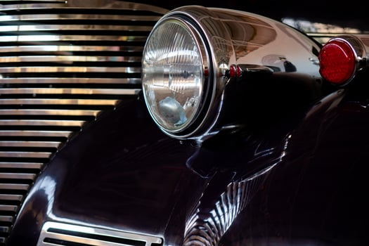 The headlight of an antique, rarity, vintage black car. photo