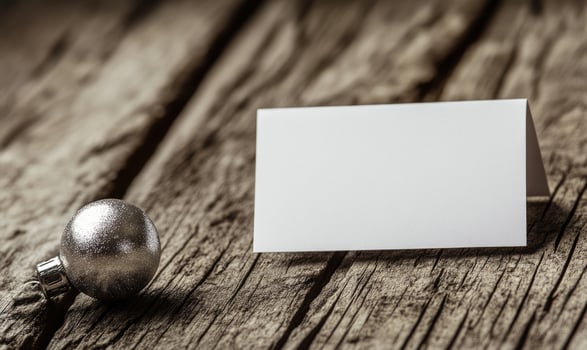 A white card with a silver ball on top of it photo