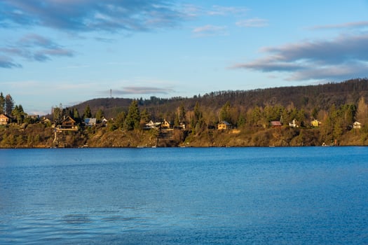 Water level shooting view of Zivohost village and Vltava river under a blue sky, Czech Republic photo
