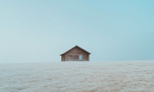 A small cabin is sitting on a snowy field photo