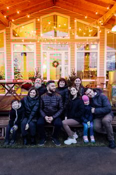 Big happy family in backyard of house. Several generations together on Christmas Eve. Grandparents, parents, children and grandchildren have fun together outdoors. photo
